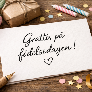 Födelsedagskort handskrivet med en penna framför och konfetti